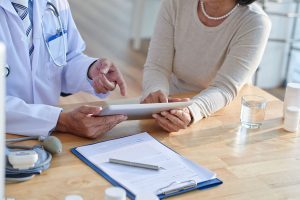 discussing records with senior patient